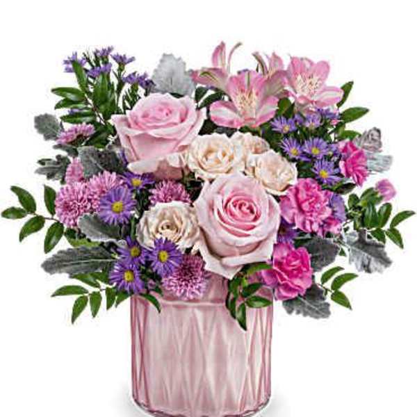 Pink and purple mixed bouquet in a pink glass vase