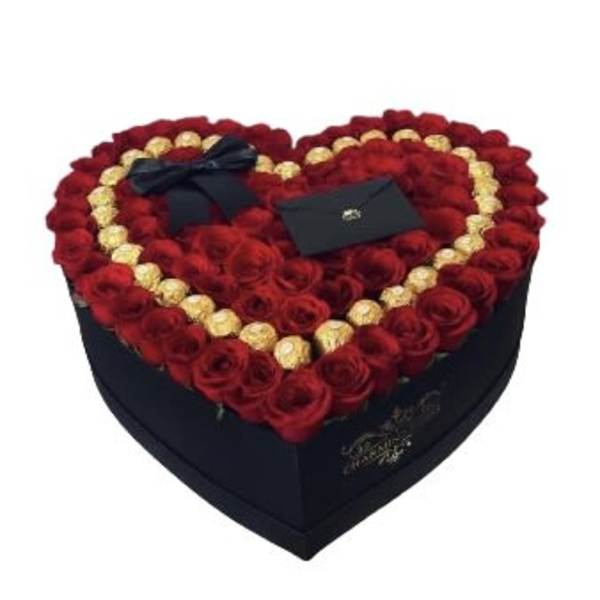 Heart-shaped box filled with red roses and gold chocolates