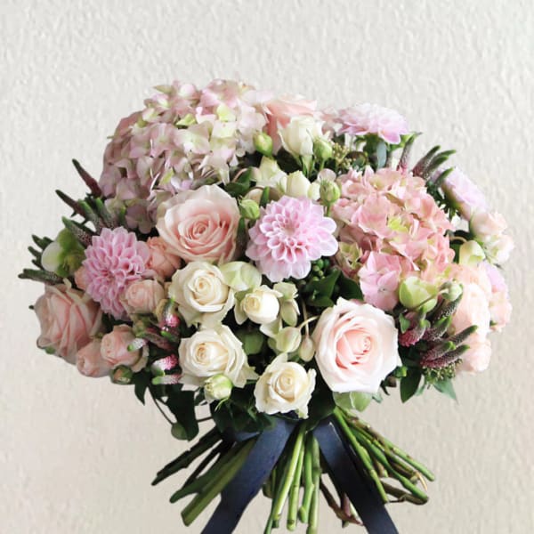 Bouquet of pale pink and white roses with hydrangeas and dahlias