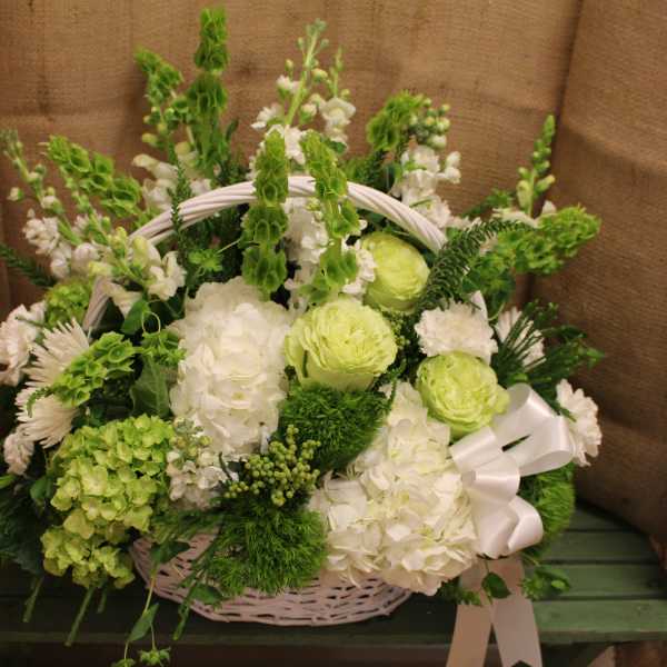 White and green flower basket with a ribbon bow