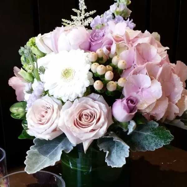 Pastel bouquet of roses, gerbera daisy, and hydrangea in a vase