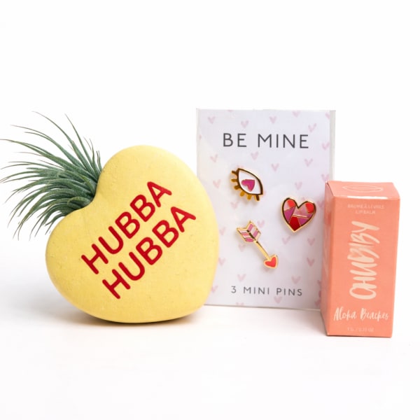 Valentine gift set with a heart-shaped item, pin card, and lip balm box