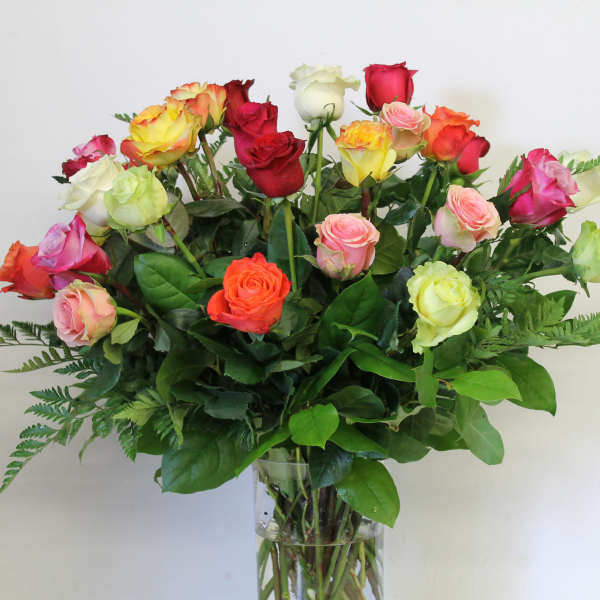 Bouquet of multicolored roses in a clear glass vase