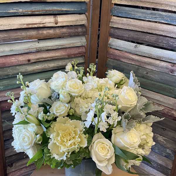 White rose and hydrangea arrangement in a glass vase