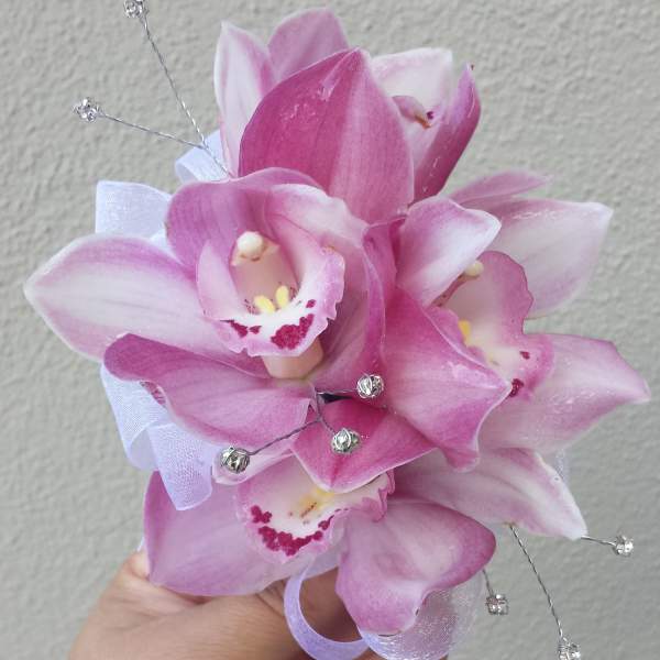 Small pink orchid corsage with ribbon and silver bead accents