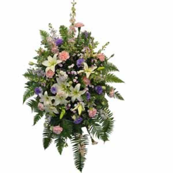 Standing floral spray with white lilies, pink and purple blooms