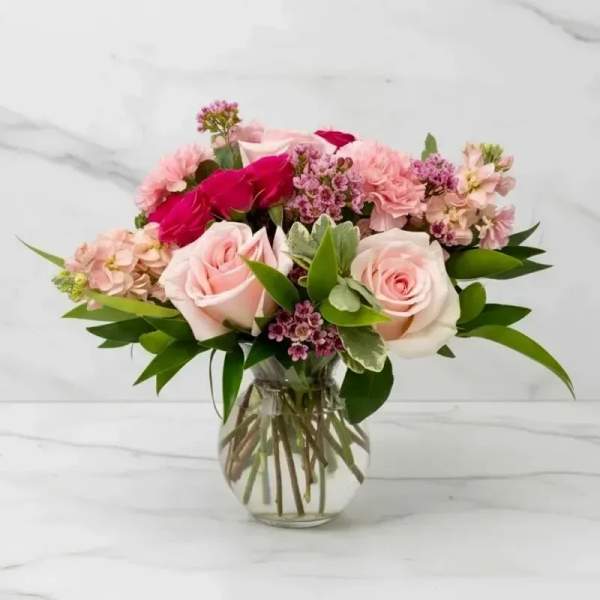 Pink and red rose bouquet in a clear glass vase