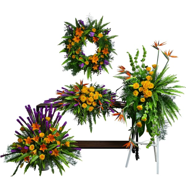 Four floral funeral pieces with orange lilies, yellow roses, and purple accents