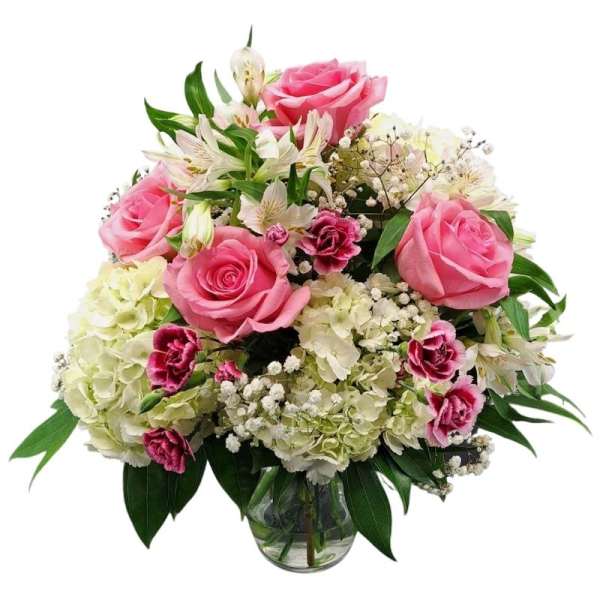 Pink roses and white flowers in a glass vase
