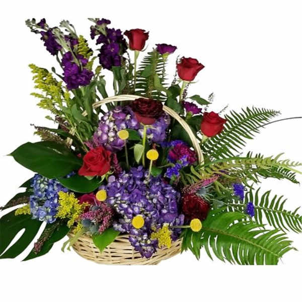 Basket arrangement with purple hydrangeas, red roses, tall purple flowers and lush ferns.