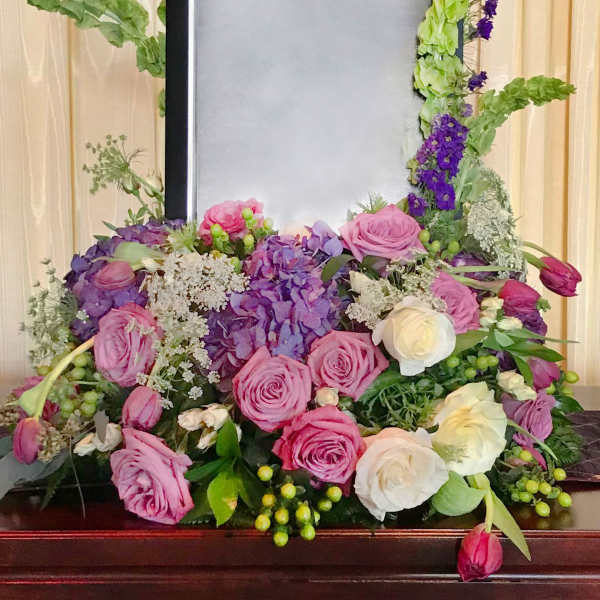 Floral frame arrangement with pink and white roses around a blank center panel