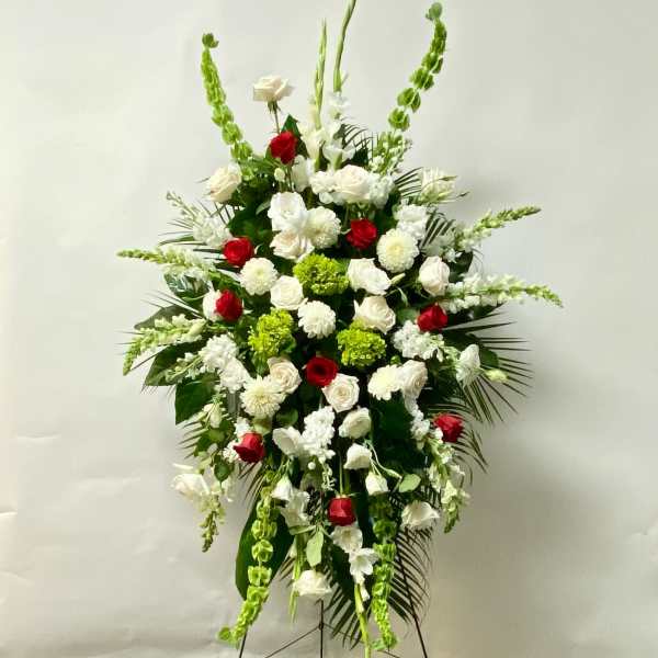 Standing floral spray with red and white roses and green accents