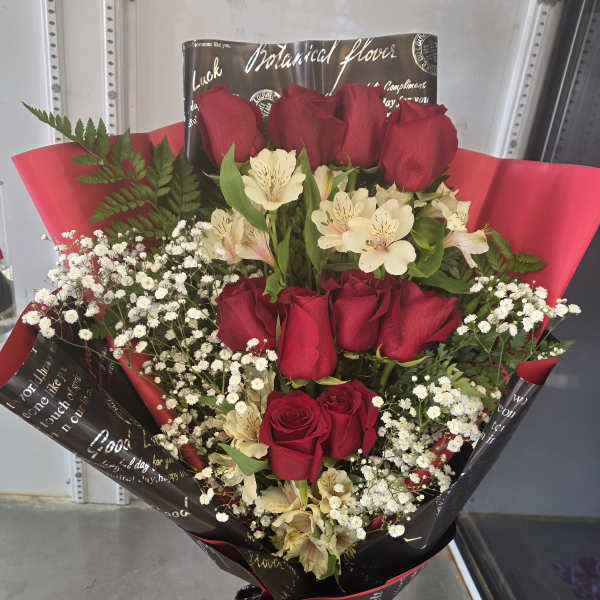 Bouquet of red roses and white alstroemeria in black and red wrap