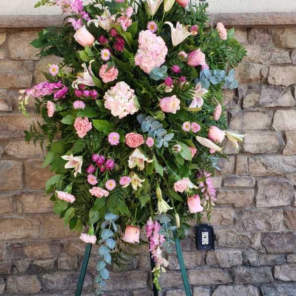 Tall pink and white floral standing spray on a tripod easel