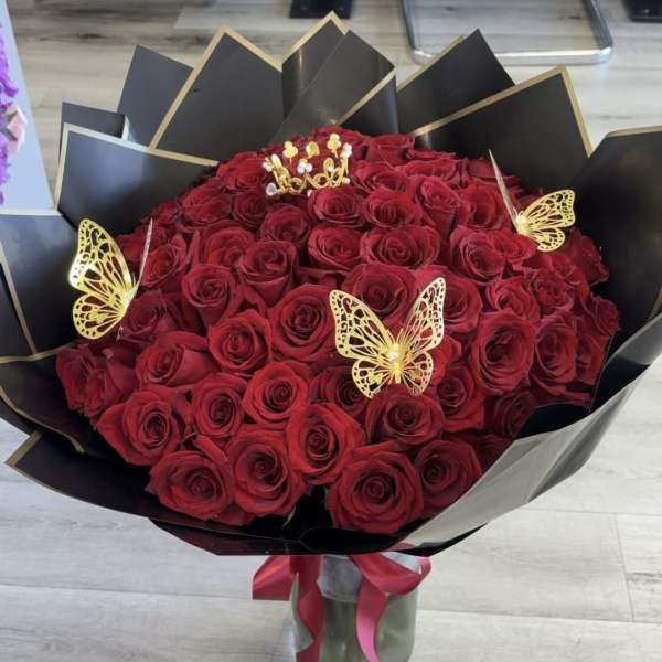 Bouquet of red roses with gold butterfly accents in black wrap