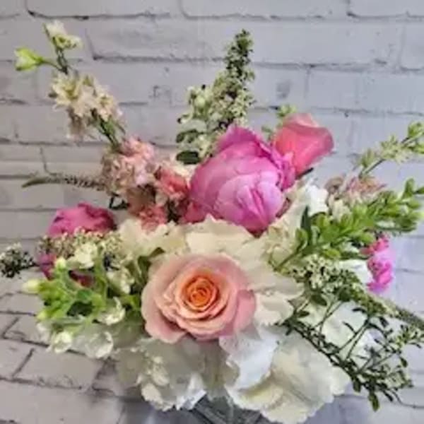 Pink and white mixed flower bouquet in a glass vase