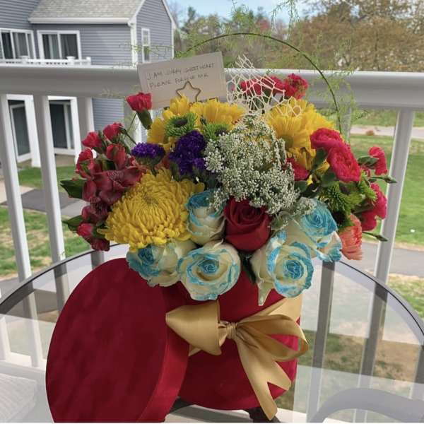 Mulit colored arrangement in a red velvet box by lav.ishbouquets