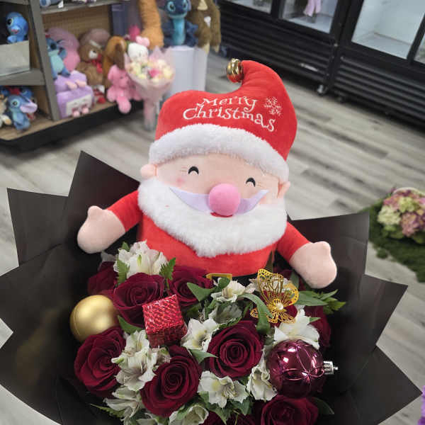 Bouquet of red roses with a Santa plush and Christmas ornaments