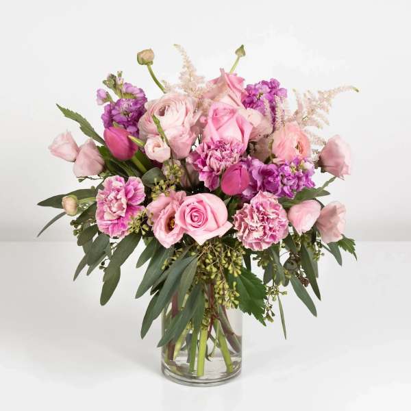 Pink and purple mixed bouquet in a clear glass vase