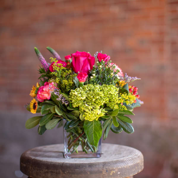 Pink and yellow mixed bouquet in a clear glass vase
