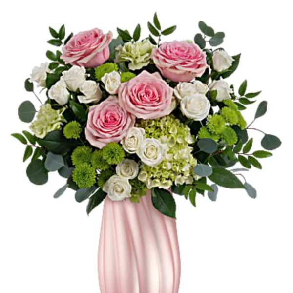 Pink and white rose arrangement in a tall pink vase