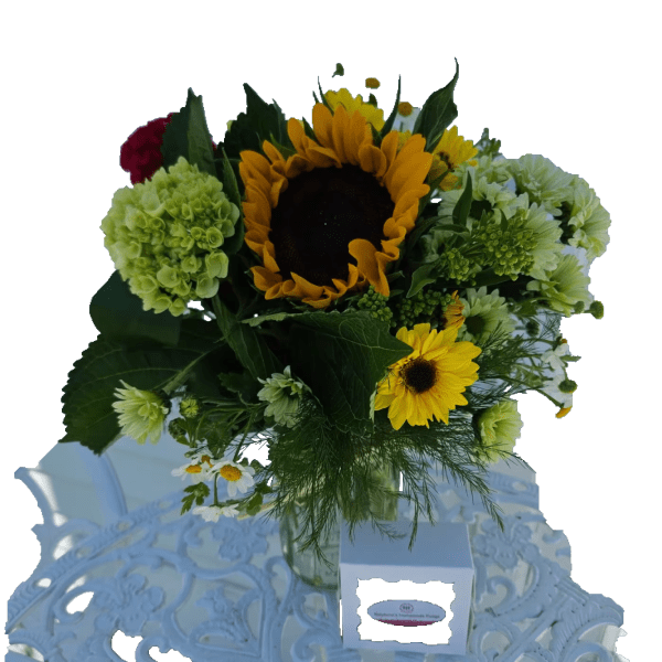 Sunflower bouquet with green and white blooms in a glass vase