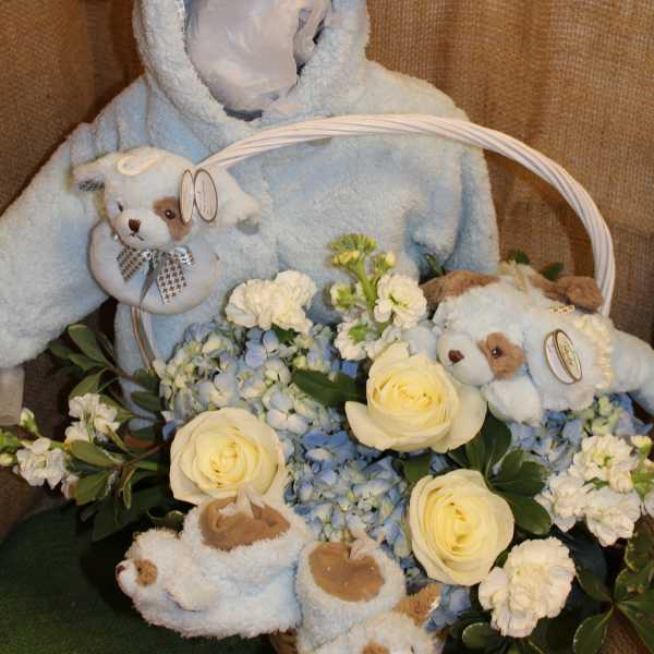Plush puppy basket with cream roses and blue hydrangeas