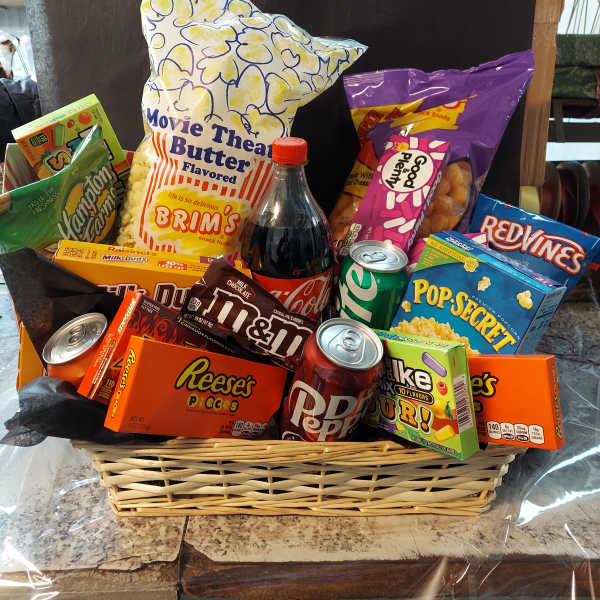 Basket of assorted snacks and soda wrapped in clear cellophane
