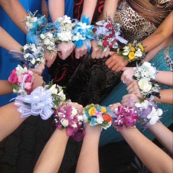 Group of floral wrist corsages in assorted colors held together
