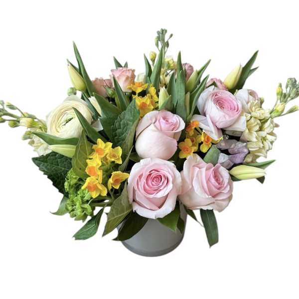 Pink roses and yellow flowers arranged in a gray vase