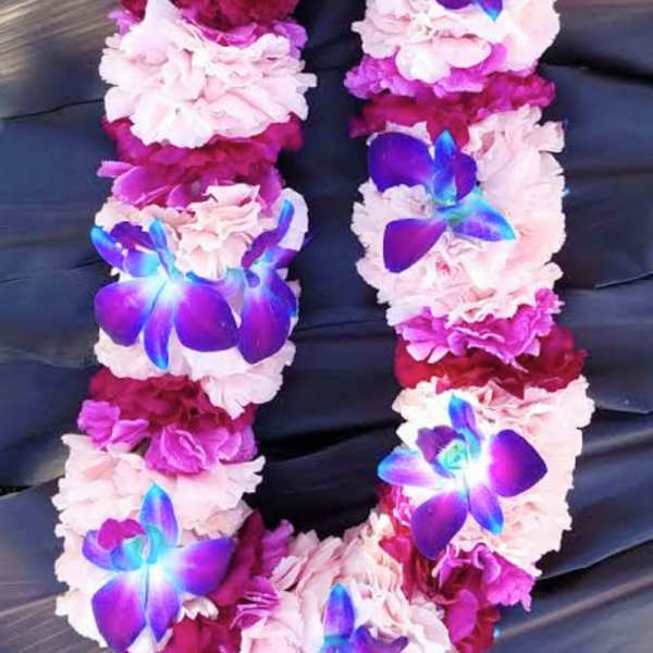 Flower lei with pink and magenta blooms and blue-purple orchid accents