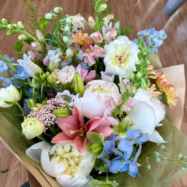 Hand-tied bouquet of pastel flowers with lilies and peonies