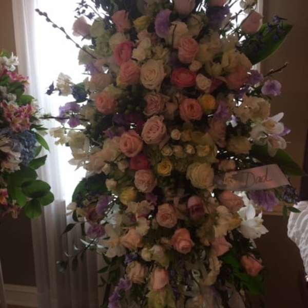 Tall pastel floral standing arrangement with roses and orchids