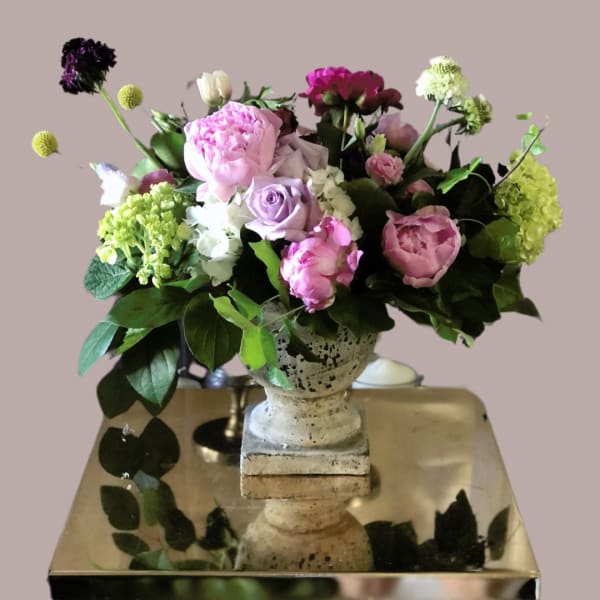 Mixed pink and purple bouquet in a stone vase