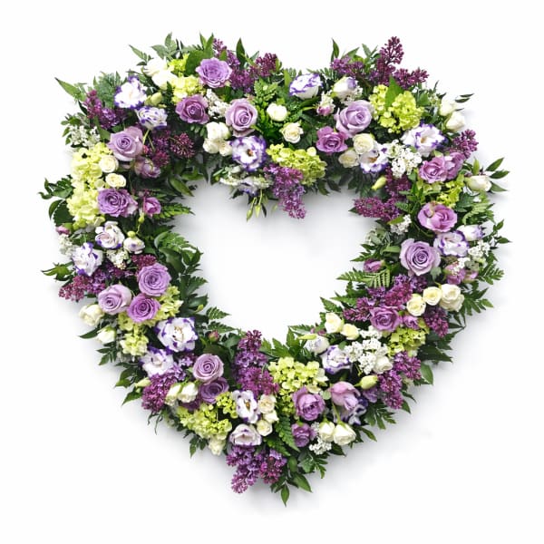 Heart-shaped floral wreath with purple, white, and green flowers