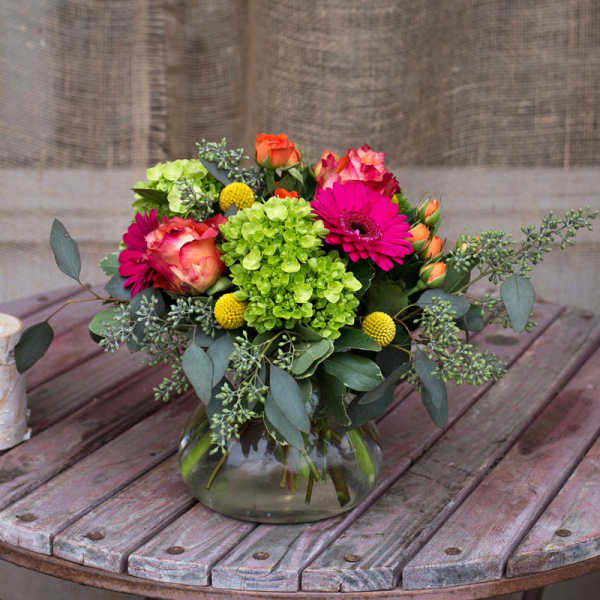 Bouquet of pink and orange flowers in a glass vase