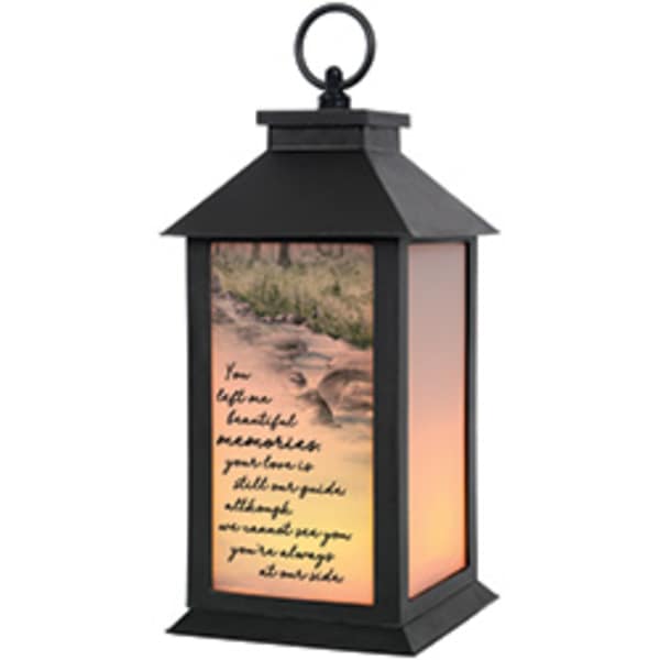 Black lantern with a printed scenic panel and warm light inside