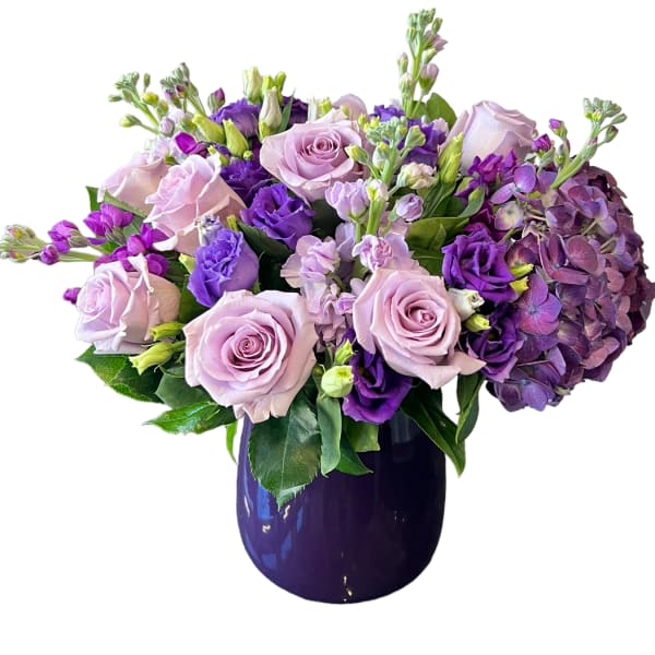 Lavender and purple bouquet in a dark vase