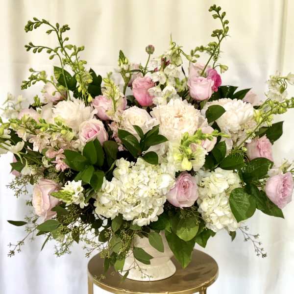 Pink and white floral arrangement in a white vase