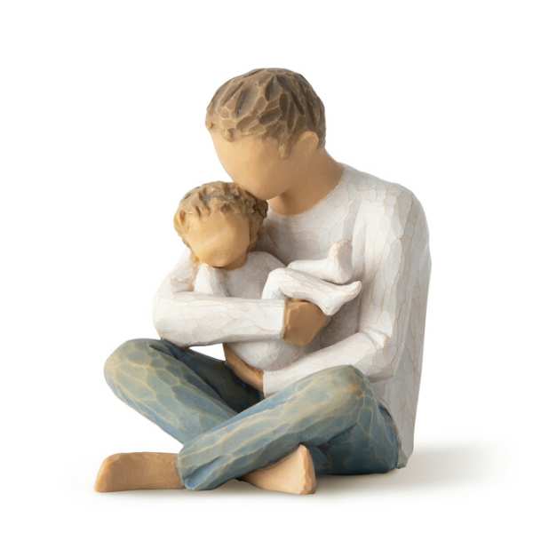 Wooden figurine of a seated adult holding a child