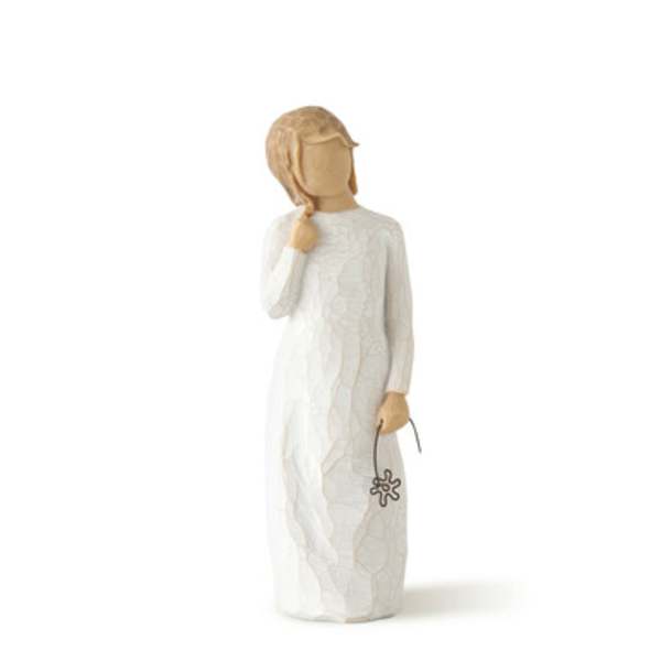 Wooden figurine in a white dress holding a small flower