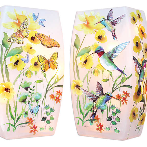 Pair of pink glass candle holders with yellow flowers, butterflies, and hummingbirds