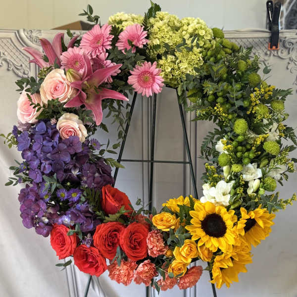 Large floral wreath with pink, purple, red, yellow, and white flowers