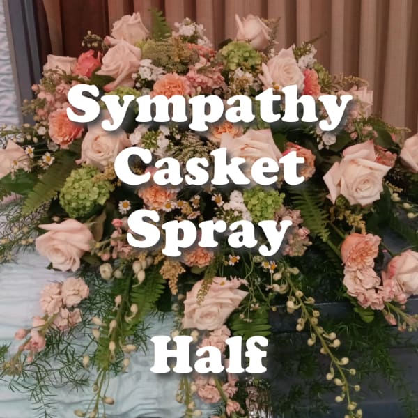 Half casket spray with peach and cream roses and carnations with soft green accents
