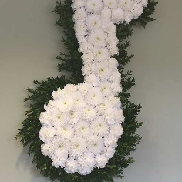 White floral number 7 arrangement with dark green foliage