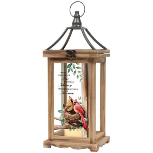 Wooden lantern with a bird nest and two birds inside