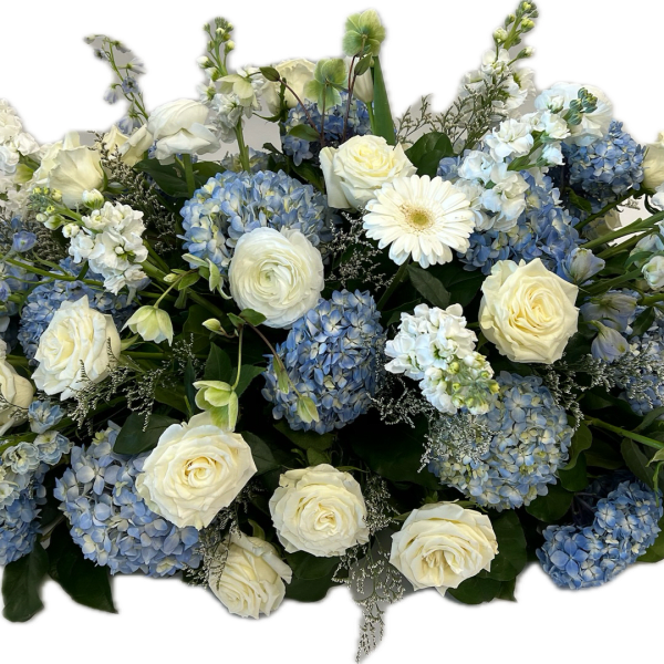 Blue hydrangeas and white roses arranged in a low centerpiece