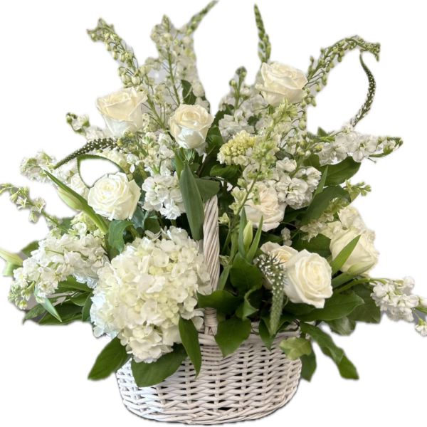 White roses and hydrangeas in a white wicker basket
