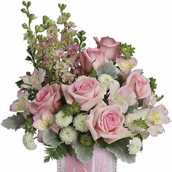 Pink roses and alstroemeria in a clear square vase