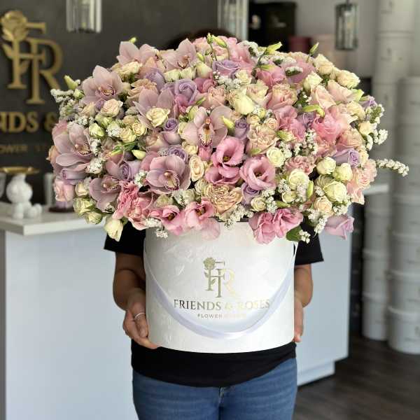 Large pastel bouquet in a white hatbox with pink and lavender flowers